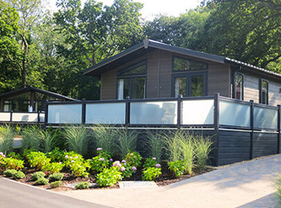 AB Sundecks Picket Glass on raised decking surrounding the lodge