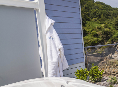 AB Sundecks Picket Glass with gown hanging next to a hot tub