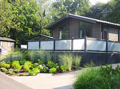 AB Sundecks Picket Glass on raised Decking surrounding a Lodge