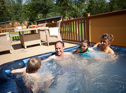 AB Sundecks Picket Panels, Picket Glass and Decking with a family in a hot tub