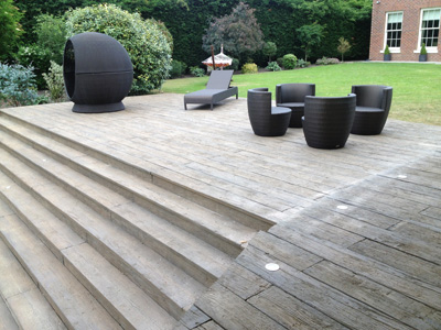 AB Sundecks Decking and Picket Glass in garden surrounding trees with Hot Tub in center